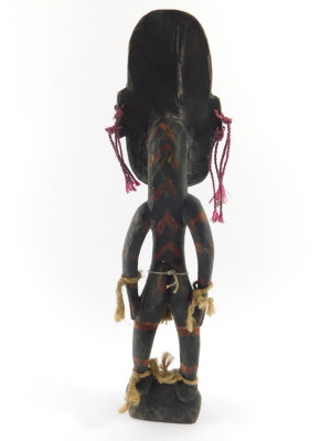A Papua New Guinea Sepik carved wooden figure, modelled in standing pose, with a mask type head, inset shell eyes, painted all over in traces of red, with carved foliate decoration, 42cm high. - 3