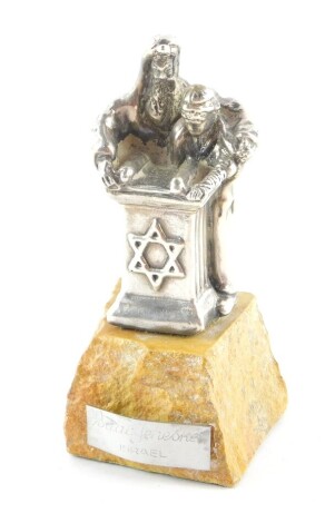 Isiah Aac Yeheskel. A silver sculpture of a Rabbi and pupil reading from the Tanakh, raised on a hewn marble base, with artist plate, 11cm high.