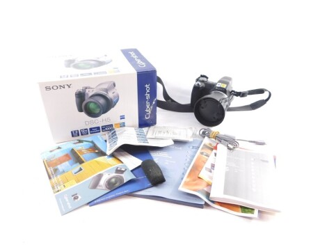 A Sony Cyber-Shot digital still camera, boxed with instructions, together with a Kodak Instamatic 28 camera, and a Sony Handycam with Mega Pixel and 120x Digital Zoom, cased with instructions. (3)