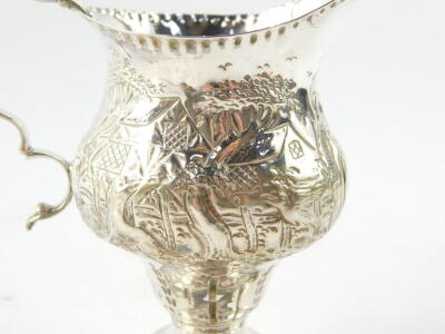 A George III silver cream jug, of ogee baluster form, embossed and engraved with homesteads, rococo shield reserve , monogram engraved, maker TS, London 1819, 2.89oz. - 3