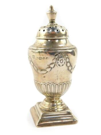 A Victorian silver sugar caster or pepperette, of fluted ogee baluster form, embossed with wreaths and flower heads, Henry Wilkinson and Company, Sheffield 1880, 1.26oz.