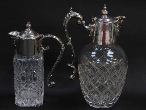 A silver plate and cut glass claret jug, with scroll handle and mask head spout, 25cxm high, and a further moulded glass and plated claret jug, 20cm high. (2)