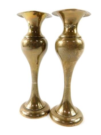 A pair of Edward VII loaded silver bud vases, of elongated baluster form, Walker and Hall, Sheffield 1904, 8.09oz.