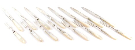 A set of eight George V silver fruit knives and forks, with mother of pearl handles, engraved decoration to the blade, Sheffield 1920.