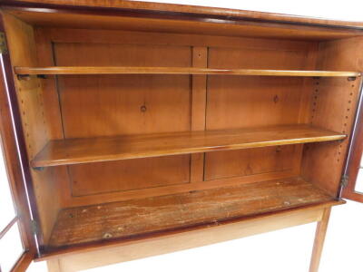 A mahogany display cabinet on stand, with a pair of astragal glazed doors opening to reveal two shelves, on a later teak console table base, raised on tapering square legs and spade feet, 173cm high, 135cm wide, 31.5cm deep. - 4