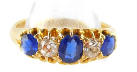 An Edward VII 18ct gold sapphire and diamond fire stone ring, diamonds approx ¼ of a carat, size L, 4.5g.