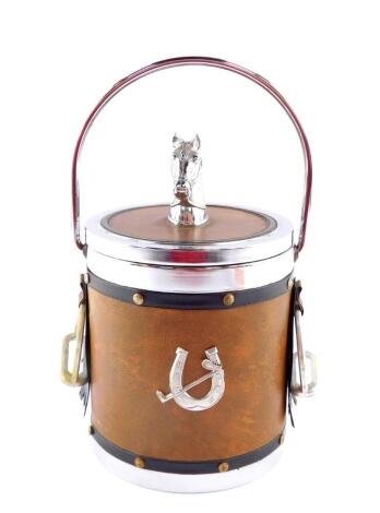 A mid 20thC novelty equestrian ice bucket, bound in faux leather, with swing handle, horse's head knop and stirrups to the side, 28cm high.