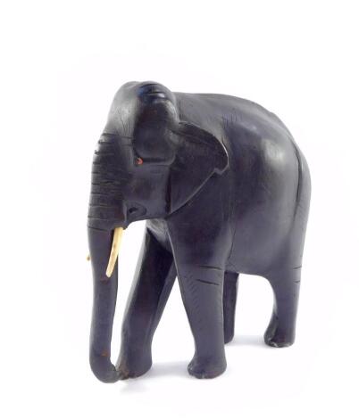 A carved ebony figure of an Indian elephant, in standing pose, 25.5cm high.