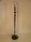 An early 20thC carved mahogany standard lamp with a reeded column