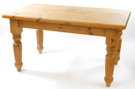 A pine kitchen table, the seven plank top raised on turned and fluted legs, 81cm high, 152cm wide, 90cm deep.