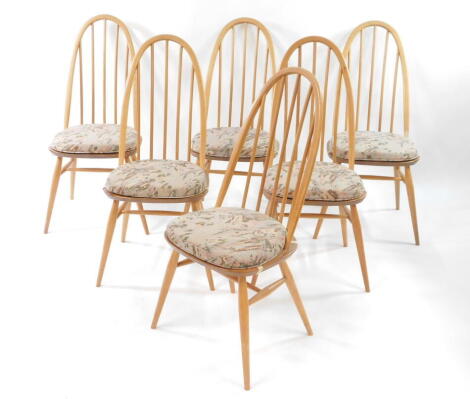 A set of six Ercol light elm and beech Quaker style stick back dining chairs, raised on turned legs united by an H frame stretcher.