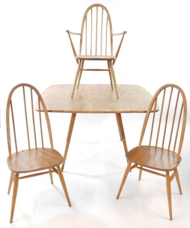 An Ercol model 383 light elm and beech drop leaf dining table, raised on tapering splayed legs, 71cm high, 61cm wide, 123cm extended, 112cm deep., together with three light elm and beech stick back Quaker dining chairs, comprising one carver and two singl