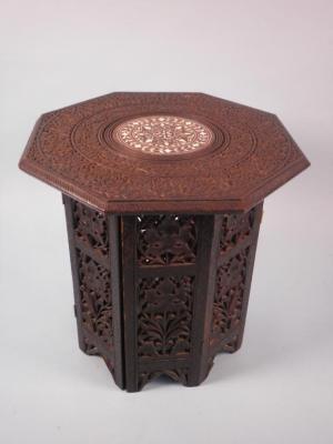 An Indian octagonal table in laid in simulated ivory and carved