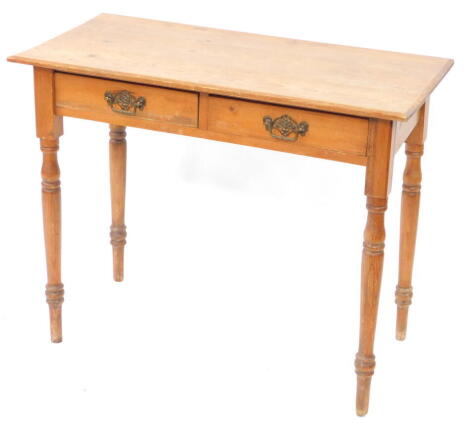 A Victorian pine side table, with two frieze drawers, raised on turned legs, 74cm high, 91cm wide, 44.5cm deep.