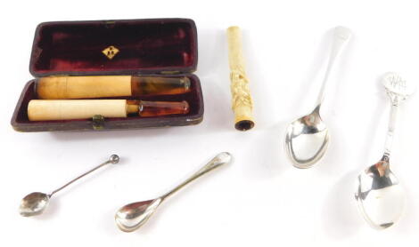 A Chinese ivory cigarette holder, carved with a dragon, two Meerschaum and amber cheroot holders, cased, a silver plated teaspoon for the Palace Hotel Hastings, silver salt and mustard spoons. (a quantity)