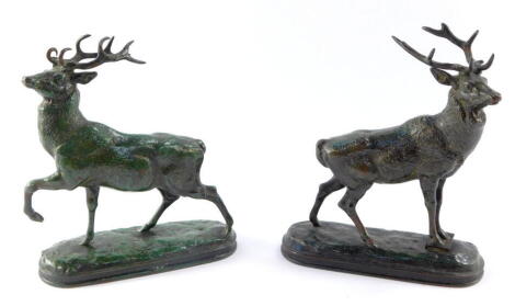 After Antoine-Louis Barye (French 1795-1875). A pair of loaded and green patinated figures of deer, cast in standing pose, raised on oval bases, bears marks, 19cm high.