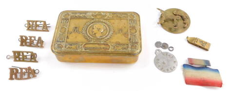 A WWI Princess Mary brass Christmas tin 1914, containing RFA and other badges, and medal ribbons.