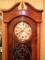 A 1930's walnut longcase clock with a silvered dial