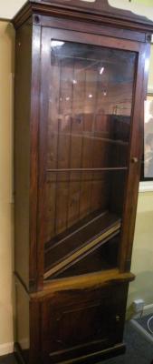 A mid 19thC narrow walnut bookcase with a single glazed door above a panelled