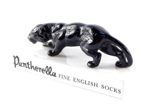 A pottery advertising figure for Pantherella, Fine English Socks, modelled with a panther raised on a rectangular base, 22.5cm wide.