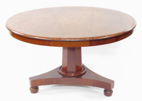 A Victorian mahogany circular tilt top breakfast table, raised on an octagonal column above a triform base, on bun feet, 73cm high, 126cm diameter.