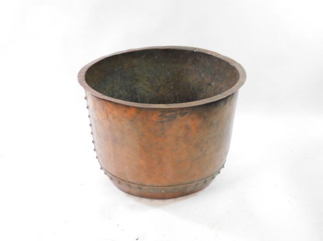 A 19thC copper pot, with riveted decoration, 54cm high, 75cm wide.