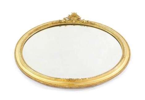 A Victorian gilt wood oval wall mirror, inset bevelled glass, 48cm high, 57cm wide.