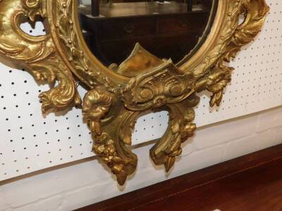 A 19thC gilt wood and gesso wall mirror, of quatrolobe form with shield floral and foliate moulding, 130cm high, 64cm wide. - 2