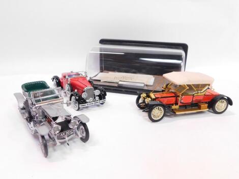 Three Franklin Mint die cast models, comprising 1910 Rolls Royce Silver Ghost., 1928 Stutz Black Hawk Speedster., and a 1907 Rolls Royce Silver Ghost with display stand, all boxed.