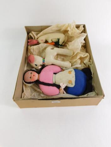 A mid 20thC felt toy rabbit, modelled standing holding a carrot, 23cm high., a model of a deer, 24cm high., and a Nora Wellings type felt doll modelled as a Dutch Girl, 37cm high. (3)