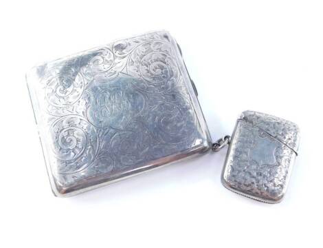 A George V silver cigarette case, of curved and hinged design, engraved with foliate scroll decoration and with a monogram 'AHI', Birmingham 1916, 3.98oz, together with a Victorian silver vesta case, with engraved decoration on a blank cartouche, Birmingh