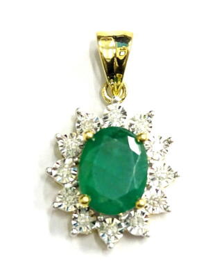 An emerald and diamond pendant, with oval emerald surrounded by tiny diamonds, in yellow metal setting, marked 750, 2.9g all in.