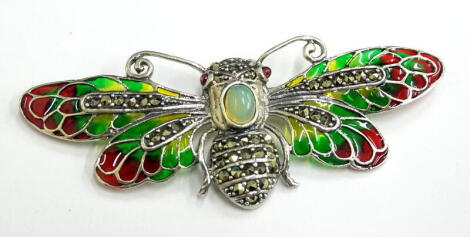 A plique-a-jour dragonfly brooch, set with opals, rubies and marcasite, in red, green and yellow colouring, white metal, stamped 925, 8cm wide.