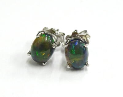 A pair of black opal earrings, each in basket setting, with butterfly backs, silver, 3.2g all in.