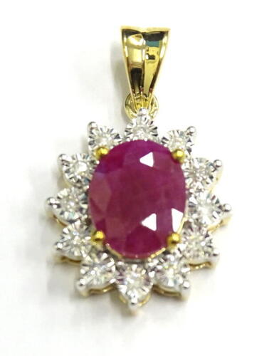 A ruby and diamond pendant, with oval ruby surrounded by round brilliant cut diamonds, white and yellow metal, marked 375, 2.3g all in.