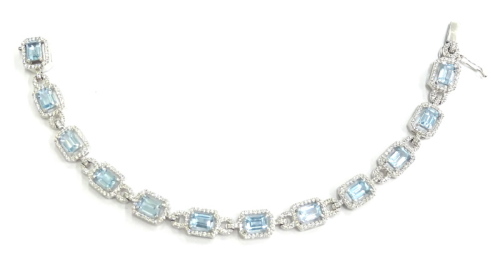 An 18ct white gold blue topaz and diamond bracelet, with rectangular cut topaz, surrounded by tiny diamonds, the topaz 9.20cts overall, the diamonds 1.90cts overall, 20cm long overall, boxed.