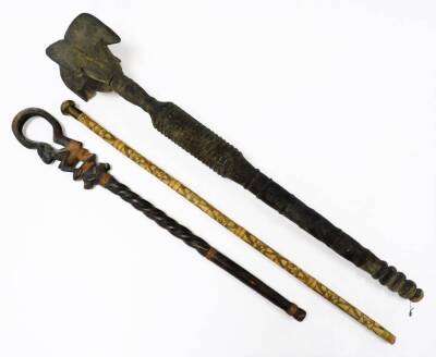 A heavily carved African staff, partially ebonised, with turned handle and elaborate top, 106cm high, a further tribal staff with turned figure end, bamboo staff with plain mushroom top. (3) - 2