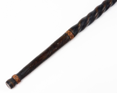 A heavily carved African staff, partially ebonised, with turned handle and elaborate top, 106cm high, a further tribal staff with turned figure end, bamboo staff with plain mushroom top. (3) - 9