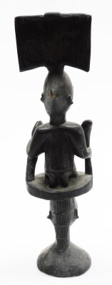 A heavily carved ebonised African tribal totem style figure, formed as two figures with elaborate features on a circular base, 54cm high. - 3