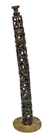 A 20thC African tribal carved pillar, of four sections formed as many figures with elaborate hair and clothing, on turned point stems, terminating on a carved round base, 85cm high.