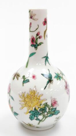 A Chinese porcelain bottle vase, decorated in coloured enamels with flowers and butterflies, four character Qianlong seal mark to base, 20thC. 19cm high.