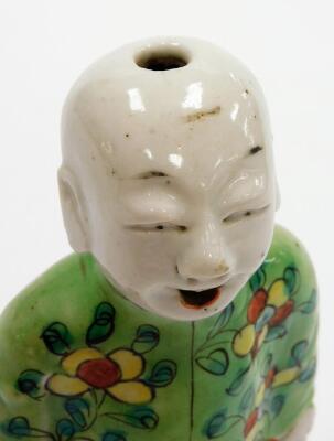 A Chinese spill holder modelled as a kneeling child with smiling expression, glazed predominantly in green, yellow and orange, 19thC, 17cm high. - 5