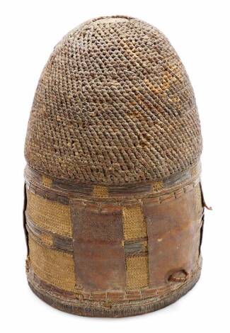 A 20thC African hide and woven measuring guard, with leather insert and entwined woven top, 28cm high. (hollow)