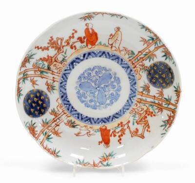 A set of four Japanese Imari porcelain plates, decorated with figures among bamboo and prunus, central underglaze blue floral medallion, four character Fuki Choshun mark (meaning Wealth, Nobility, Longevity and Youth), Meiji period. 23cm wide. - 2