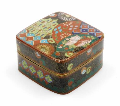 A 20thC Japanese cloisonne box and cover, profusely decorated with flowers in orange, blue, black and green, Meiji period, 7cm wide.