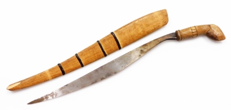 An African tribal knife, with shaped blade and wooden sheath, with entwined banding and carved stylised hoof handle, 49cm wide.