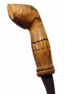 An African tribal knife, with shaped blade and wooden sheath, with entwined banding and carved stylised hoof handle, 49cm wide. - 4