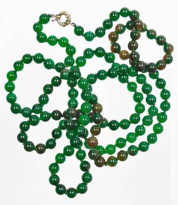 A string of jade coloured glass beads, each approx 4mm diameter, on a plain clasp, 116cm long.