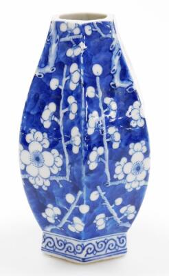 A Chinese porcelain baluster vase of octagonal section, profusely decorated with prunus flowers on a blue ground, four character Qianlong mark to base, probably early 20thC, neck reduced, 21cm high. - 4