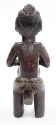 An African tribal carved figure, formed holding drum, with elaborate head dress, 34cm high. - 3